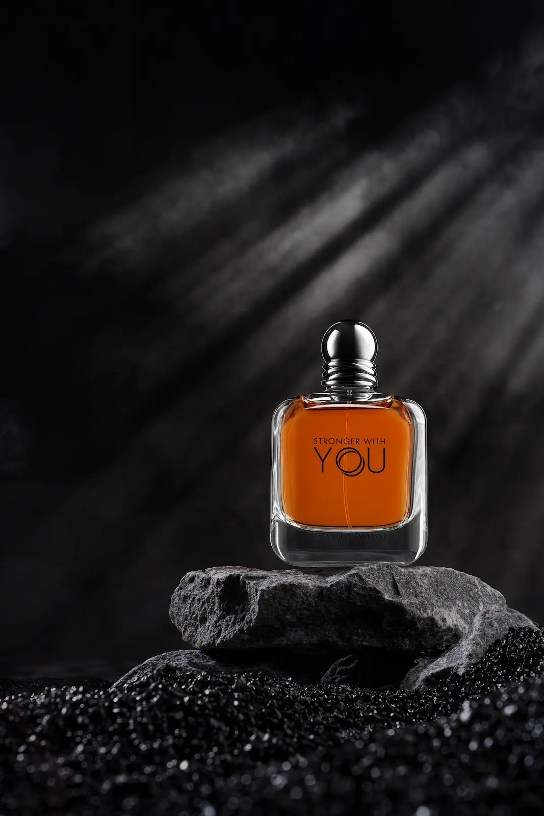 A bottle of perfume on a stone