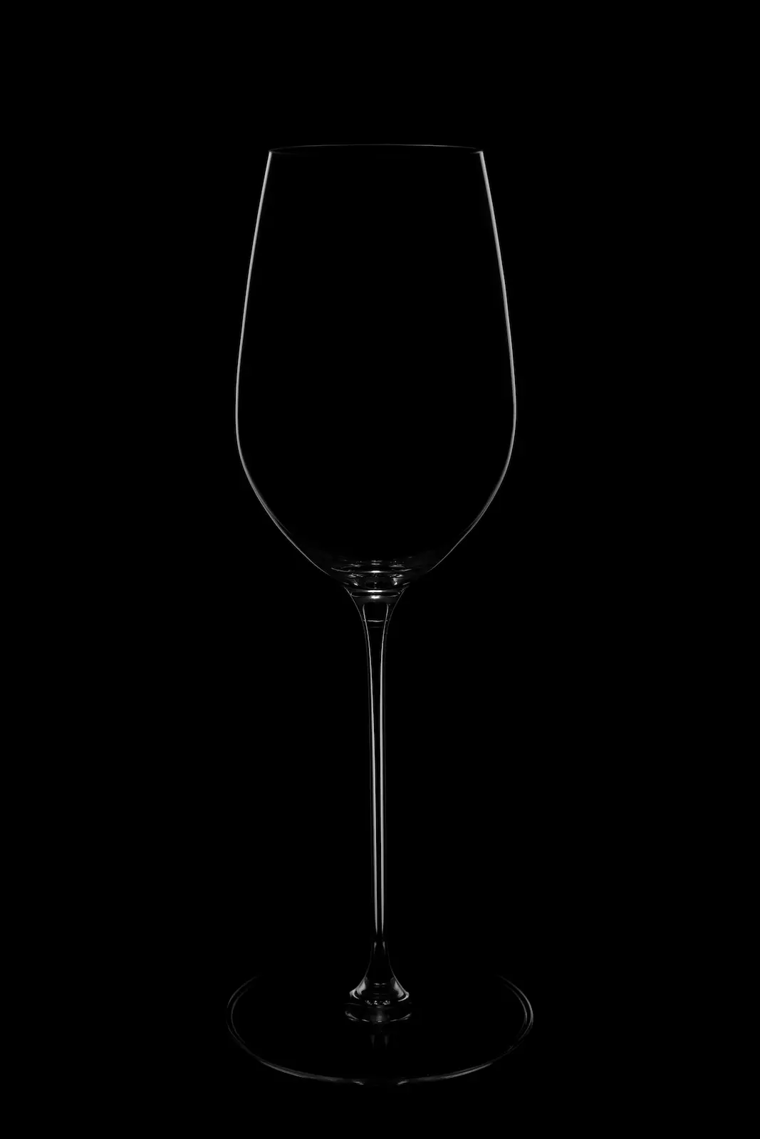 A glass on a black background with a white rim